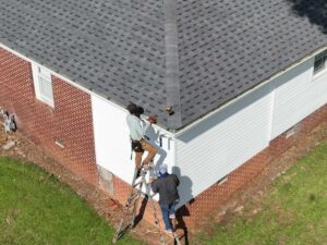 two employees fixing roof